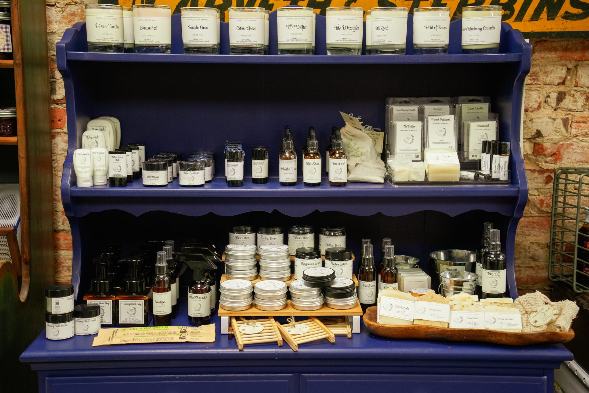Blue hutch display filled with locally made pantry jars and packaged goods