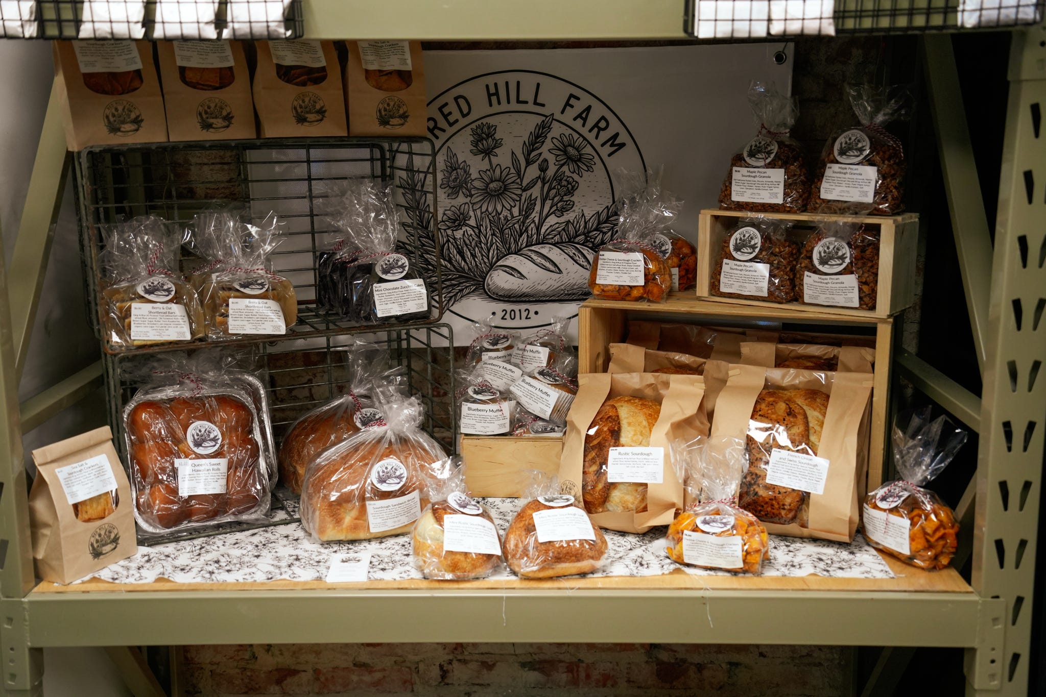 Freshly packaged baked goods on a wooden market shelf