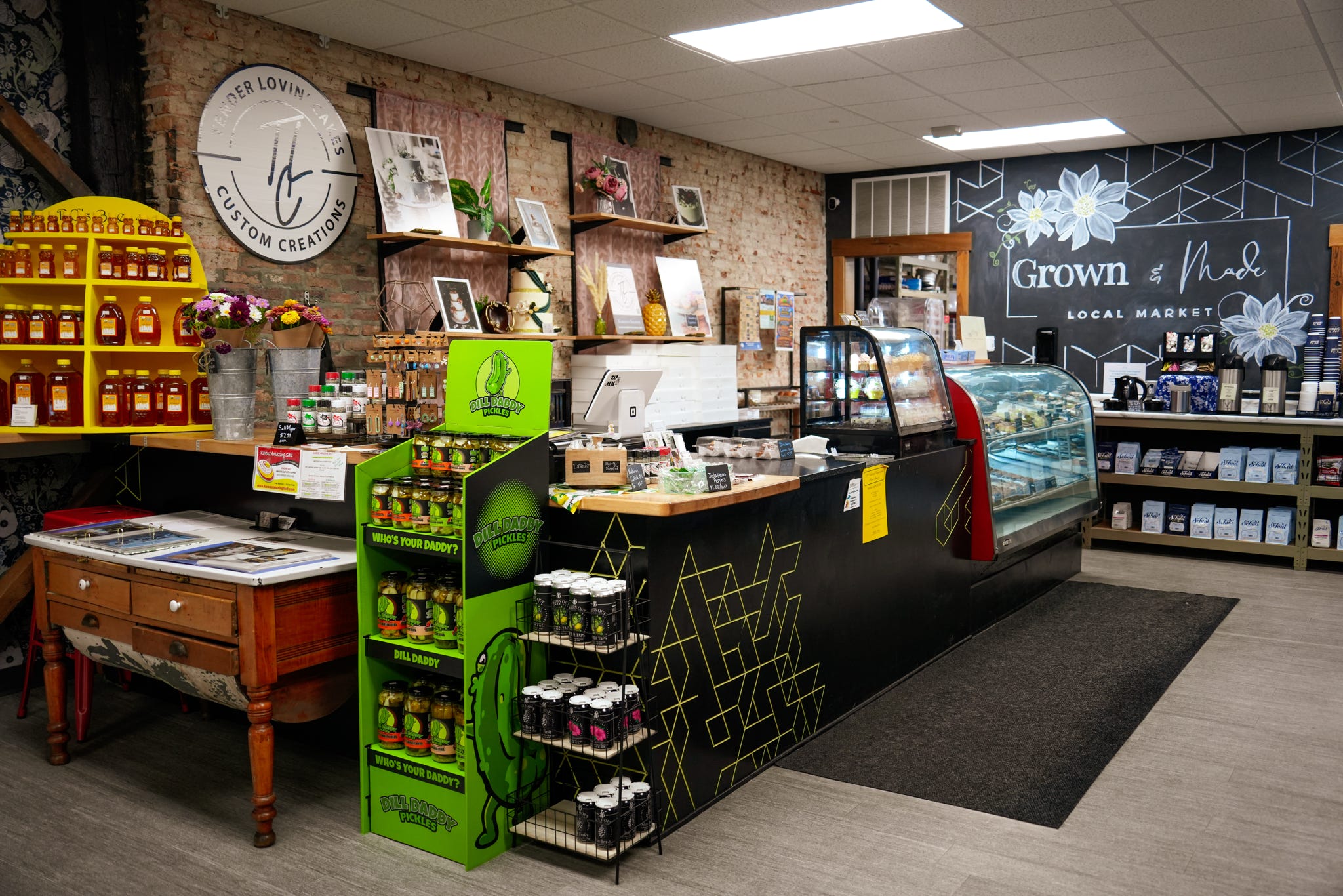 Inside Grown & Made Local Market with chalkboard menu and produce displays