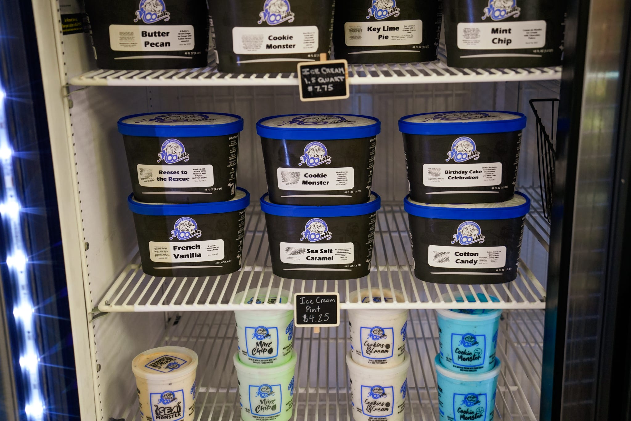 Freezer case stocked with Mooville ice cream tubs